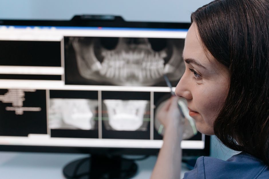 Dentist reviewing a dental X-ray for diagnosis
